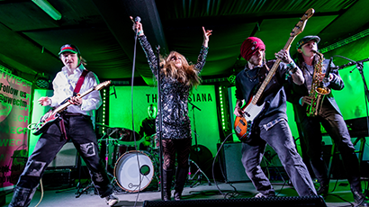 4 members of a band on stage