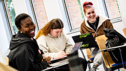 Students sat at desks laughing