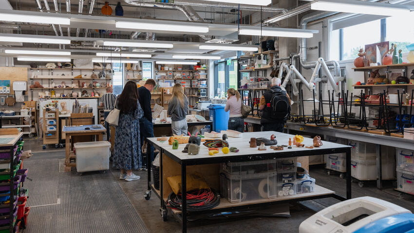 A group of prospective students being shown around the fabrication room at City Campus.