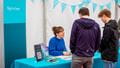 Two prospective students signing in for the Open Day at the sign in desk.