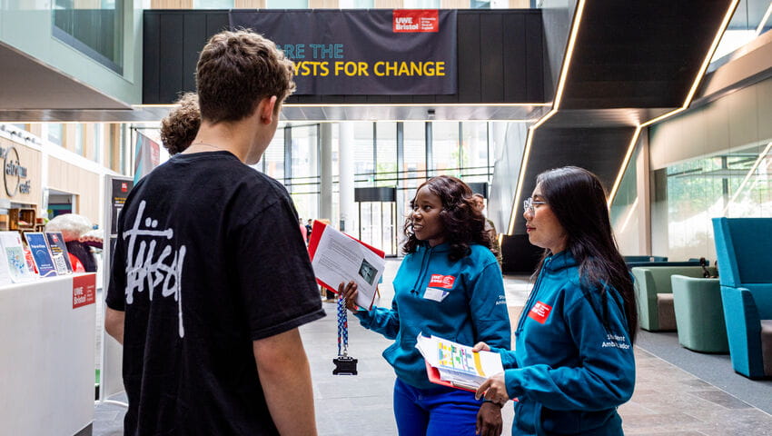 Two student ambassadors talking with prospective students in the Atrium, X Block.