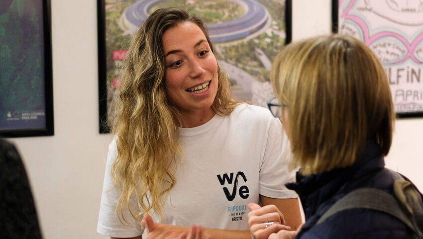 Two women talking, one with a WAVE T-shirt on.