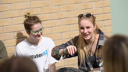 Current students sitting and talking outside Frenchay Campus accommodation.
