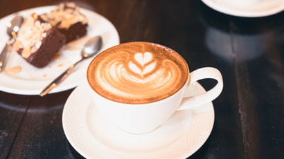 Cup of coffee with a cake