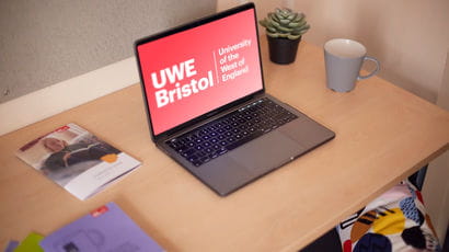 A laptop displays the UWE Bristol logo.